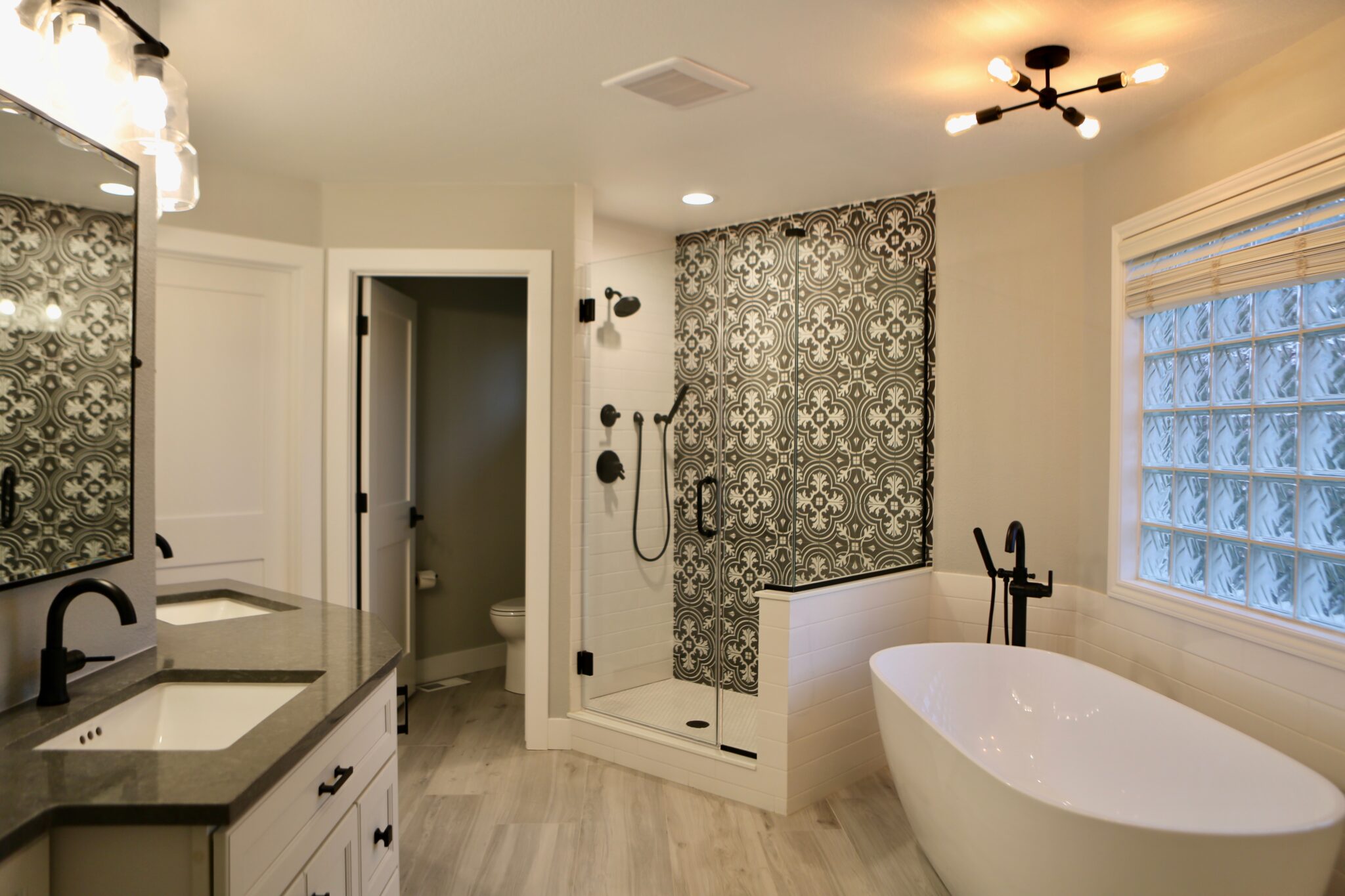 Spacious bathroom with freestanding tub and glass-enclosed shower